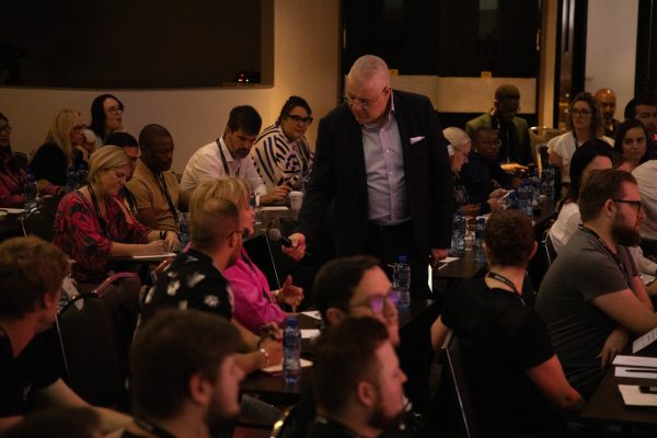 Aki Anastasiou interviews guest at marketing conference